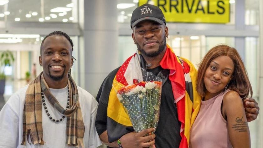 Nonso Amadi flanked by Watala and Lynda Ddane shortly after his arrival at Entebbe International Airport