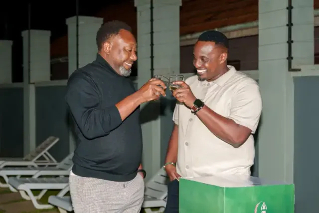James Byaruhanga and Ronald Roy Tumwizere, the National Advocacy Manager at Uganda Breweries Ltd share a light moment.